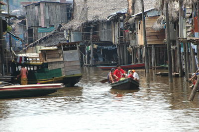 Boats sailing in canal in city