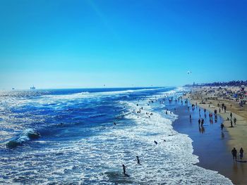 Scenic view of beach against blue sky