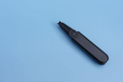 High angle view of pen on blue background