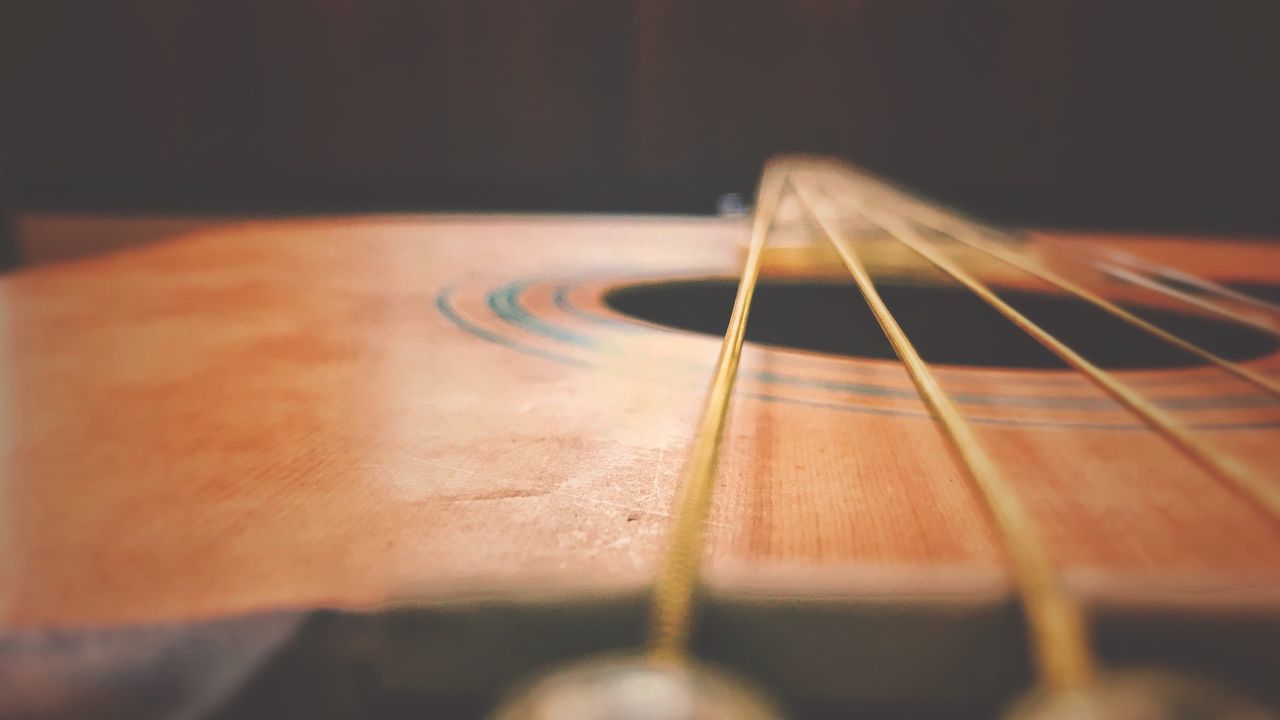 CLOSE-UP OF GUITAR IN THE ROOM