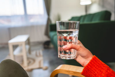 Cropped hand of woman holding wineglass