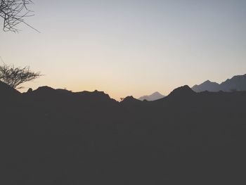 Scenic view of mountains against clear sky at sunset