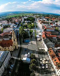 Panorama of a city square with trees and chuches