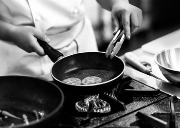 Midsection of man preparing food in kitchen