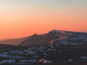 Townscape against sky during sunset