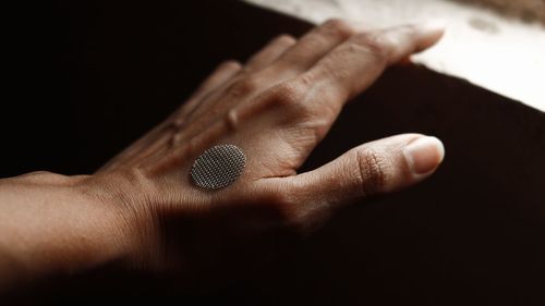 Cropped hand of person holding ring