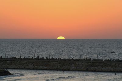 Scenic view of sea against clear sky during sunset