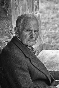 Close-up portrait of senior man sitting outdoors