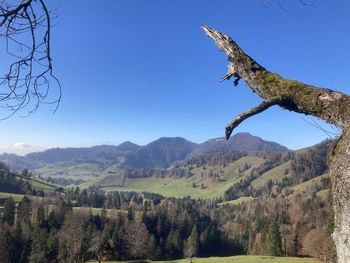 Scenic view of mountains against clear blue sky