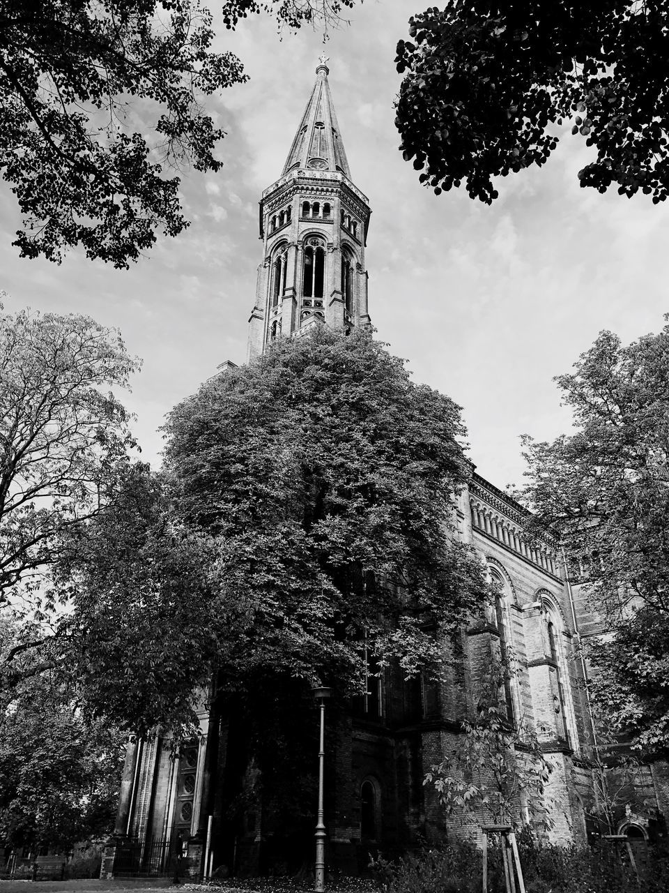 LOW ANGLE VIEW OF CHURCH TOWER AGAINST CLOUDY SKY