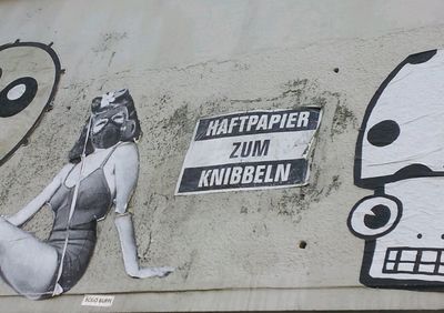 Low section of man with text on wall