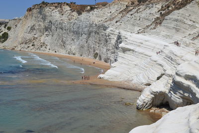 Man on sand at beach against sky