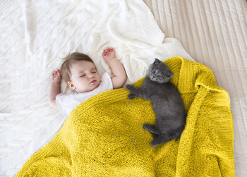 High angle view of baby sleeping on bed