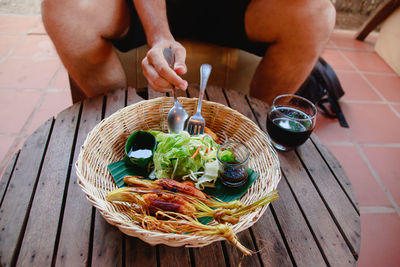 Cropped hand of person preparing food on table