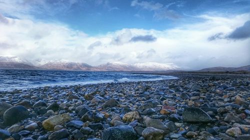 Scenic view of sea against cloudy sky