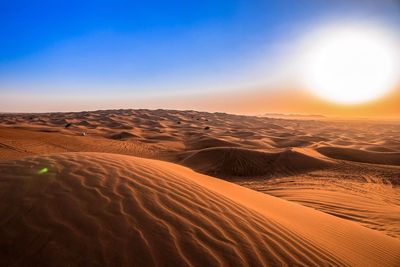 Scenic view of desert against sky during sunset