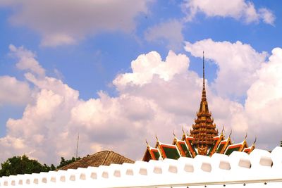 Low angle view of temple against cloudy sky