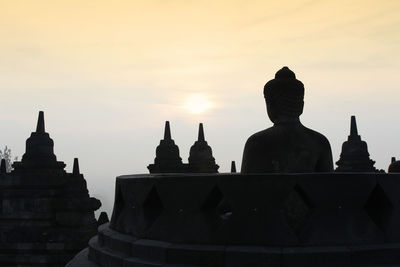 Silhouette of temple against sky during sunset