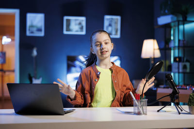 Young woman using laptop at table