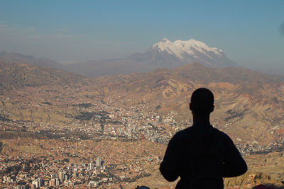 Rear view of man standing on mountain