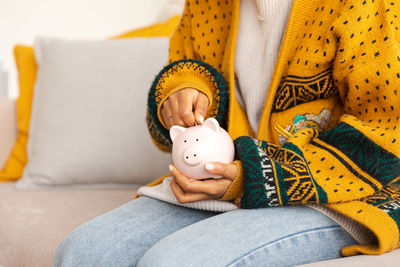 Midsection of woman with teddy bear