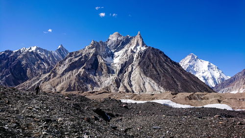 Scenic view of snowcapped mountains against blue sky