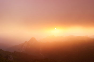 Scenic view of mountains against sky during sunset