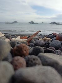 Rocks on beach against sky