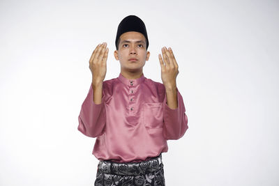 Portrait of a young man against white background