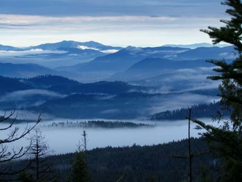 Scenic view of mountains against cloudy sky