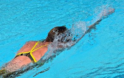 High angle view of female athlete swimming in pool