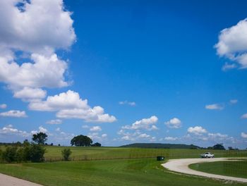 Scenic view of field against blue sky
