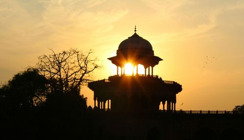 Silhouette of building during sunset
