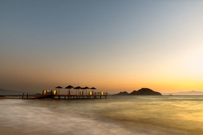 Scenic view of sea against clear sky during sunset