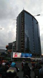 View of skyscrapers against cloudy sky