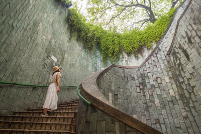 Low angle view of woman standing on staircase