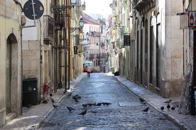 Rear view of woman walking on street in city