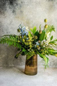 Close-up of potted plant on table against wall