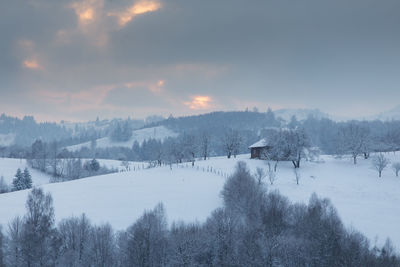 Snow covered landscape against sky