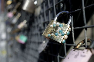 Close-up of padlocks hanging on metal grate