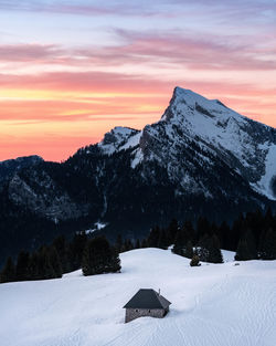 Scenic view of snowcapped mountains against sky during sunset