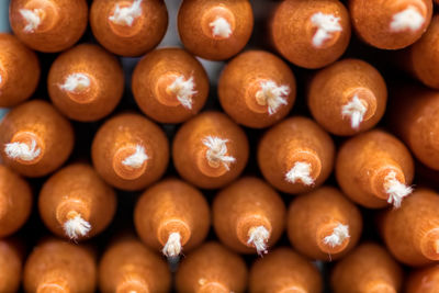 Close-up of stack of hand crafted orange candles