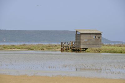 Lifeguard hut on beach against clear sky