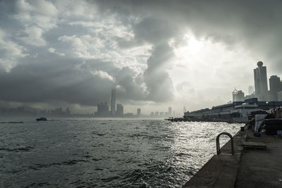 Distant view of city against cloudy sky