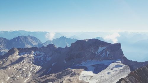 Scenic view of mountains against clear sky in winter