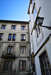 Low angle view of buildings against clear blue sky