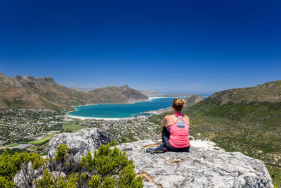 Rear view of woman looking at view against sky