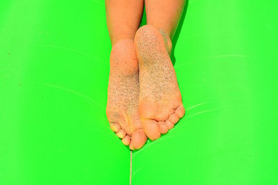 Low section of woman on wet leaf