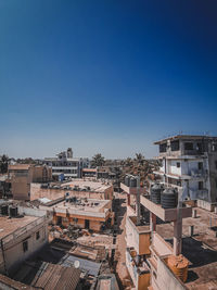 High angle view of buildings against blue sky