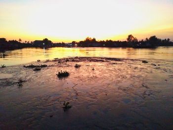 Scenic view of lake against sky during sunset